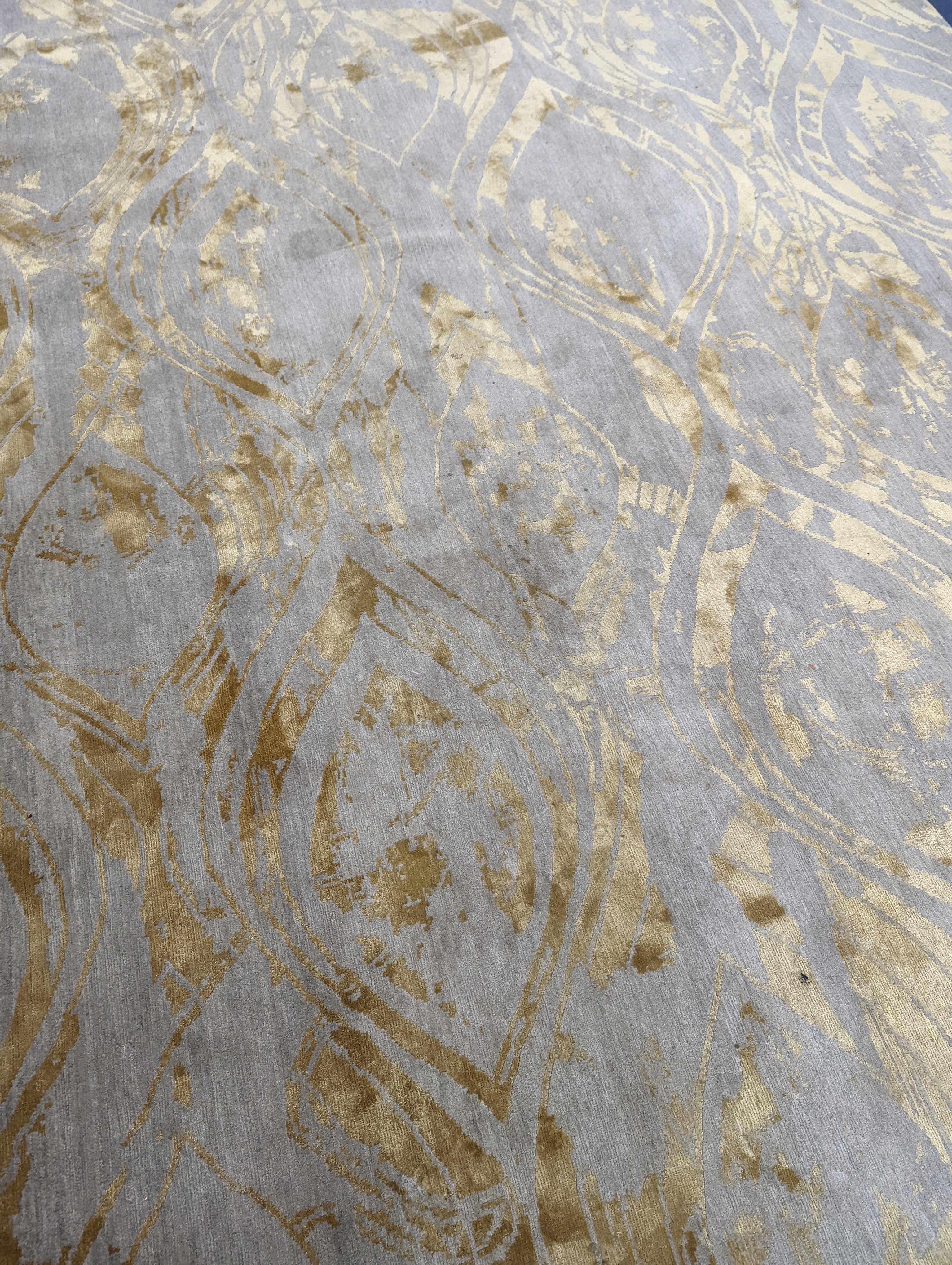 A contemporary 'Son' Nepalese wool and silk stone grey and gold carpet, 490 x 270cm